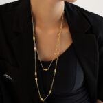 The golden double-layer beaded sweater chain exudes a grand, high-end and light luxury feel. It is a long titanium-steel layered necklace that is a bestseller for autumn and winter